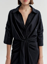 Woman wearing a black cotton top on a white background