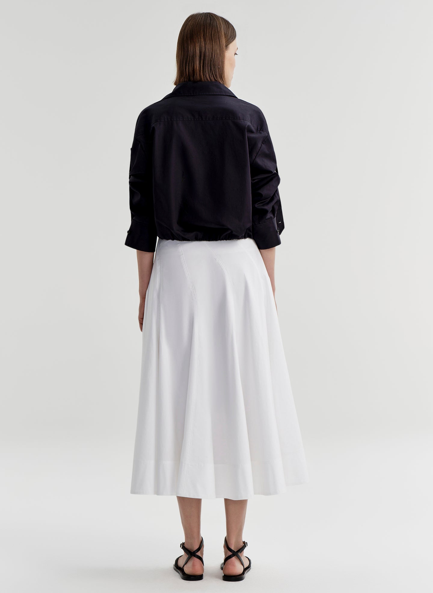 woman wearing navy blue button up shirt and white skirt