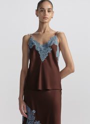 woman wearing brown camisole with blue lace trim and matching skirt