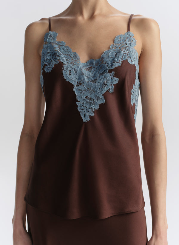 woman wearing brown camisole with blue lace trim and matching skirt