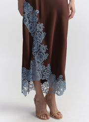woman wearing brown camisole top with light blue lace and matching skirt