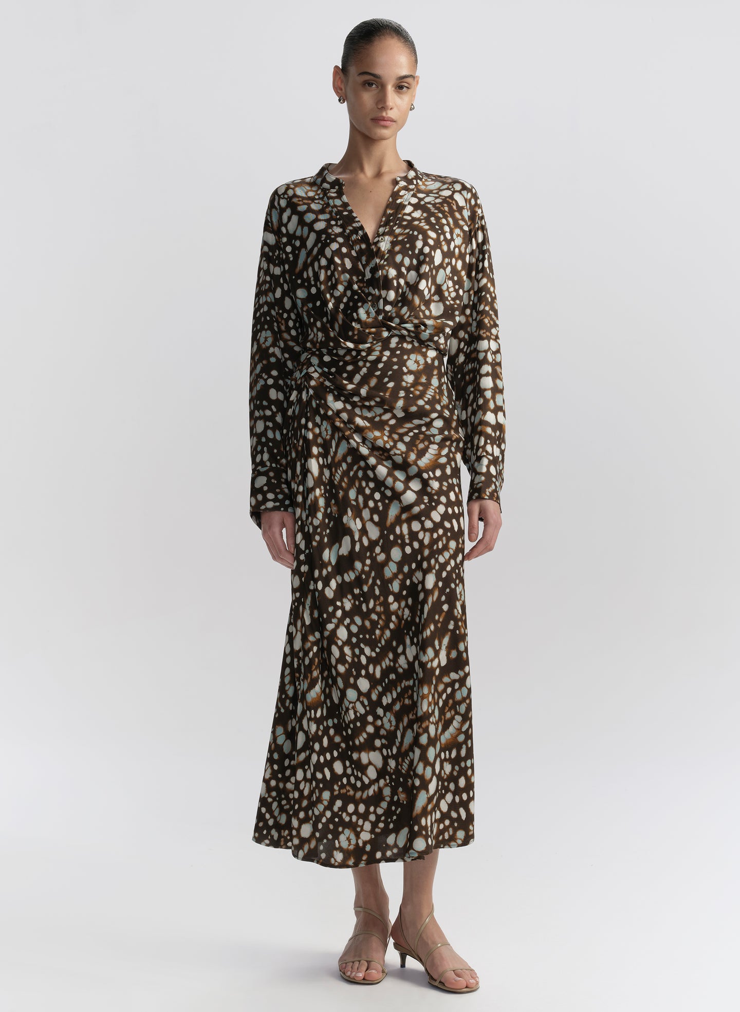 woman wearing brown patterned top and matching midi skirt