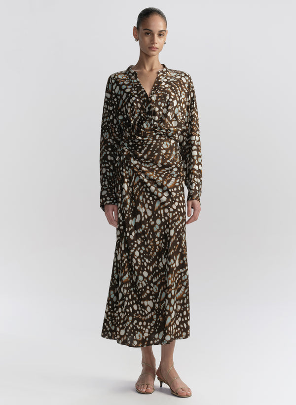 woman wearing brown patterned top and matching midi skirt