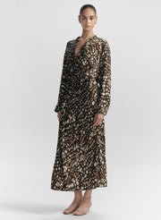 woman wearing brown patterned top and matching midi skirt