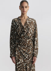 woman wearing brown printed top and matching midi skirt