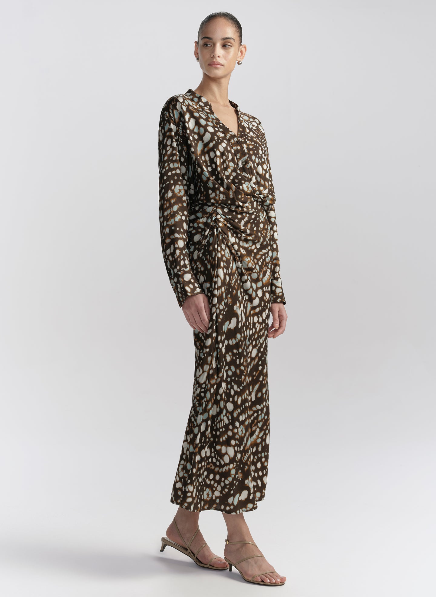 woman wearing brown printed top and matching midi skirt