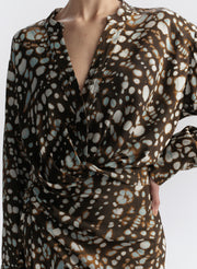 woman wearing brown printed top and matching midi skirt