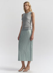 woman wearing light blue sleeveless top and matching midi skirt