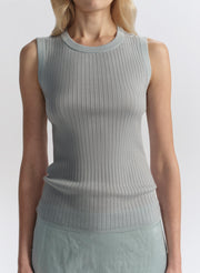 woman wearing light blue sleeveless top and matching midi skirt