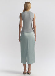 woman wearing light blue sleeveless top and matching midi skirt