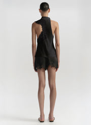 Black lace outfit worn by a model on a white background