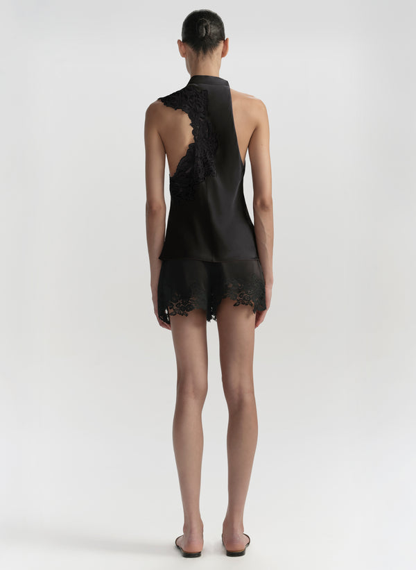 Black lace outfit worn by a model on a white background