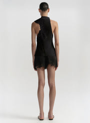 Black one-shoulder outfit worn by a model on a white background