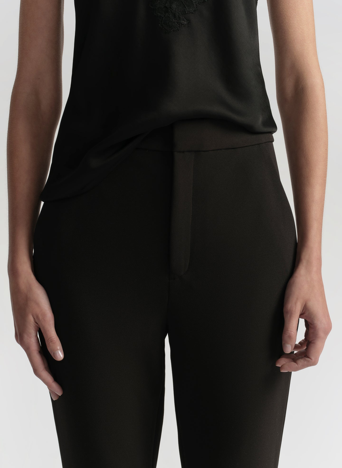 woman wearing black camisole top and black pants