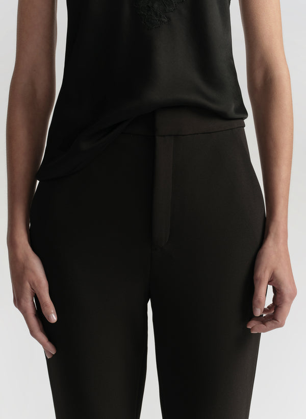 woman wearing black camisole top and black pants