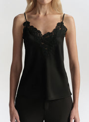 Black lace-trimmed camisole worn by a model on a white background