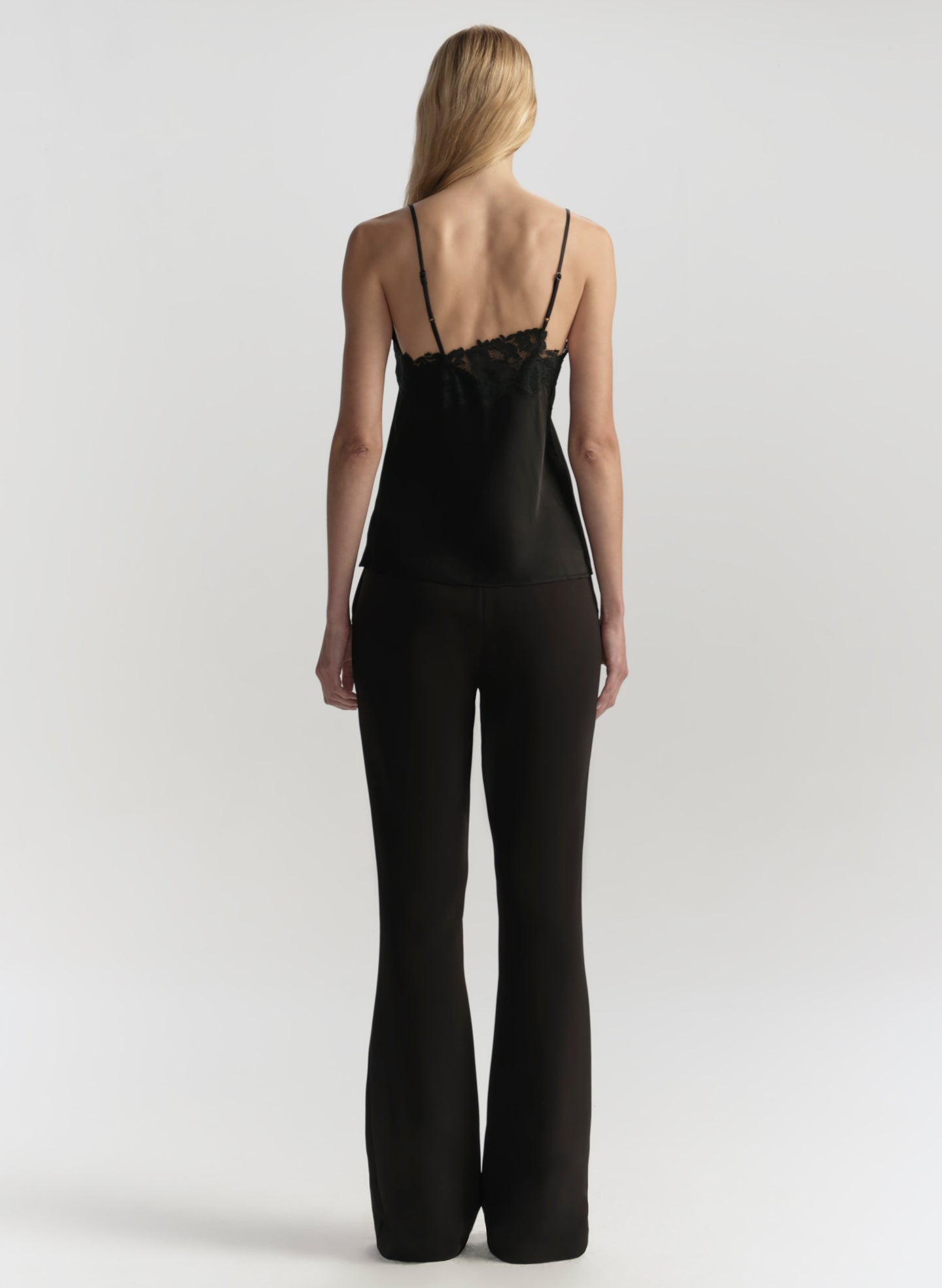 Person wearing a black jumpsuit on a white background