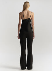 Person wearing a black jumpsuit on a white background