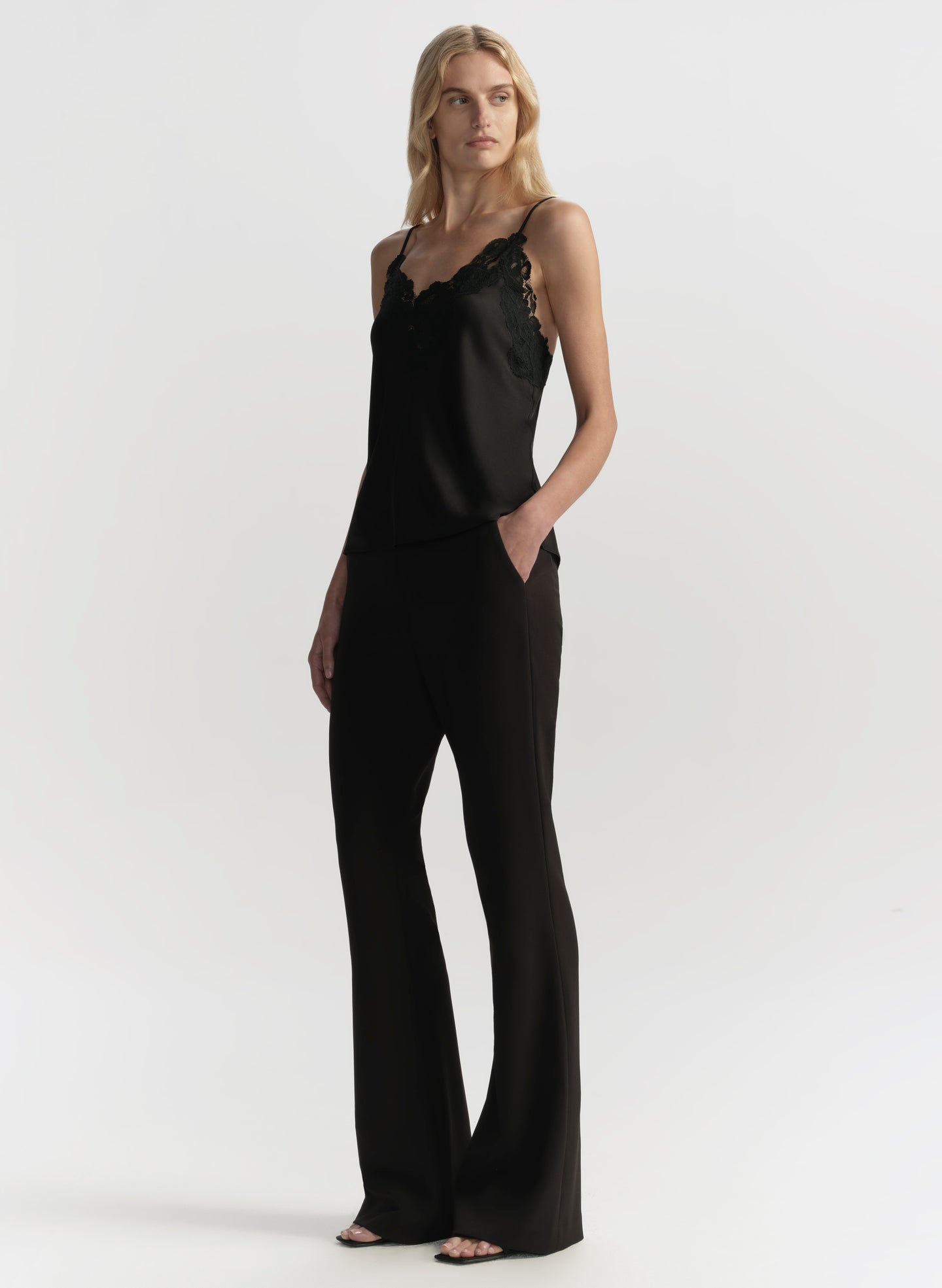 Woman wearing a black jumpsuit on a white background