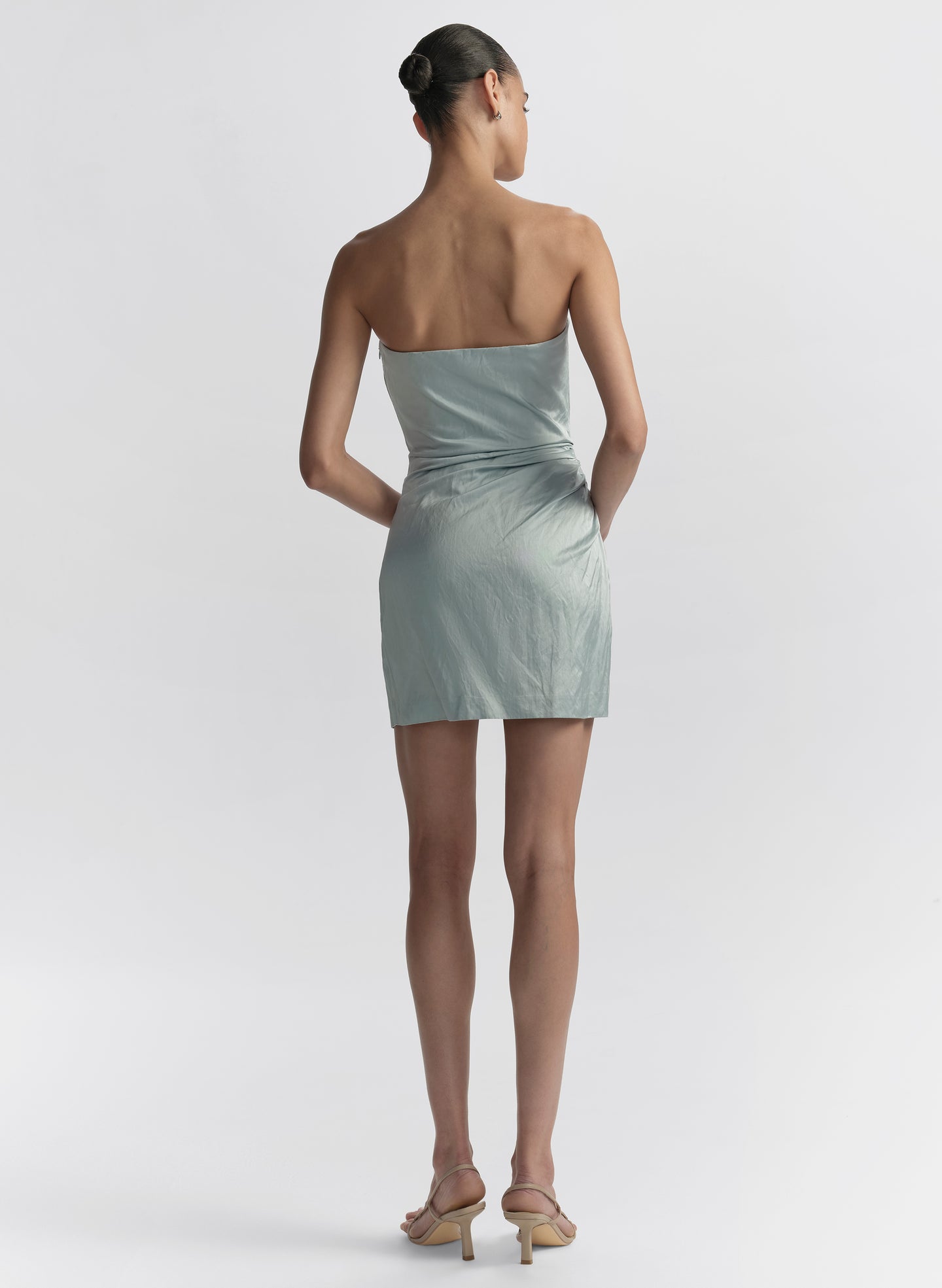 woman wearing light blue strapless mini dress