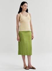 woman wearing yellow tank top and green midi skirt
