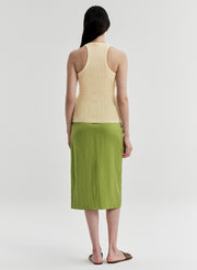 woman wearing yellow tank top and green midi skirt