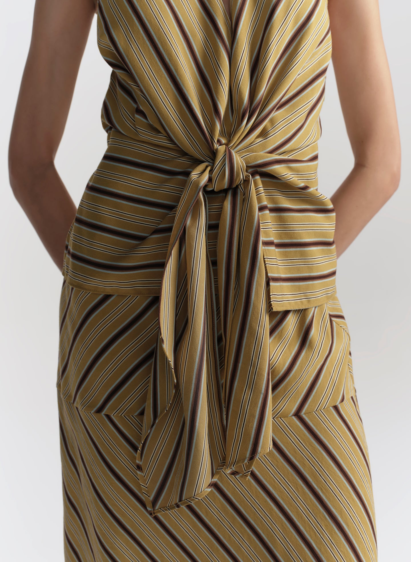 Striped top with a knot detail on a white background