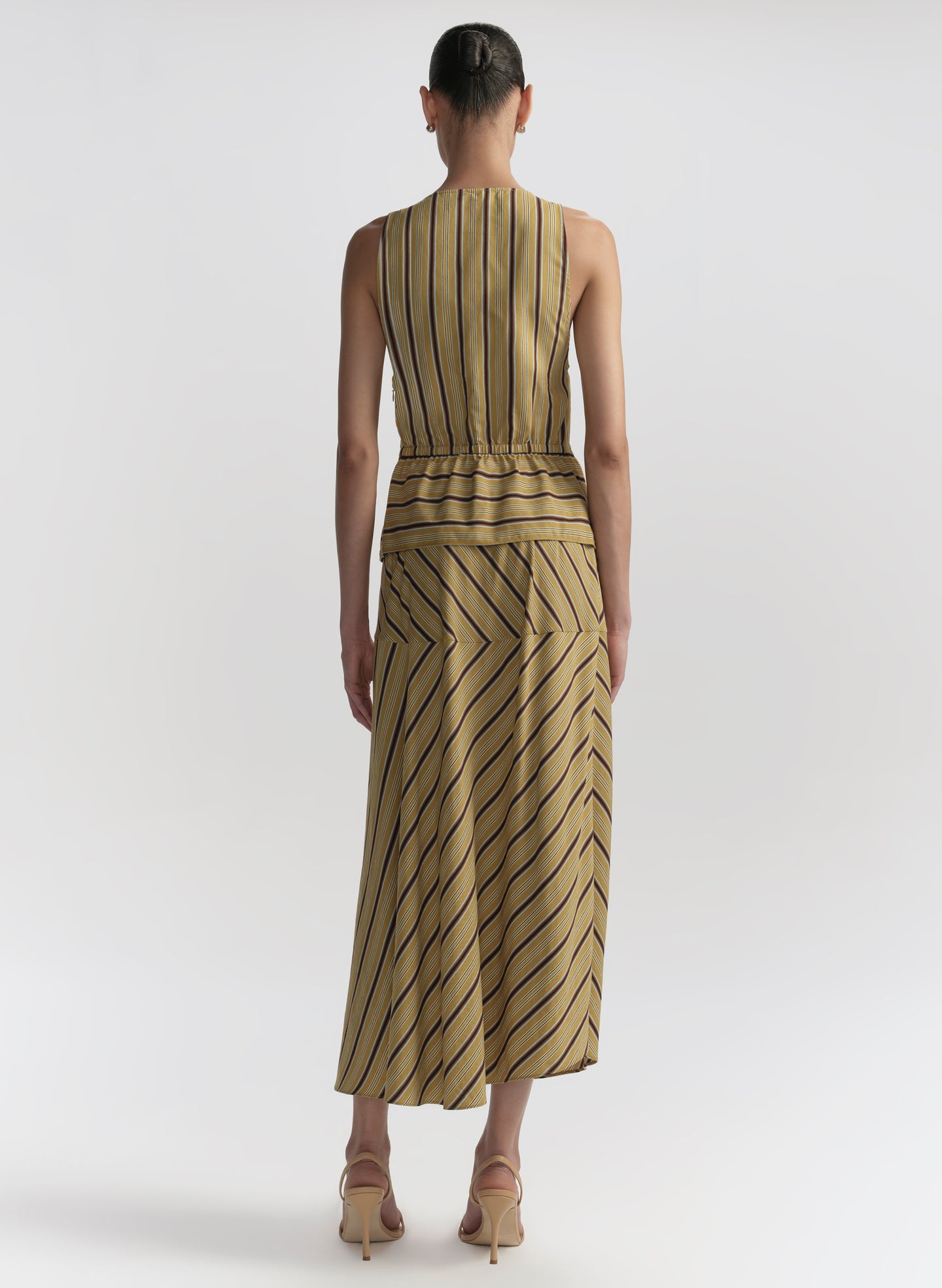 woman wearing striped top and matching midi skirt