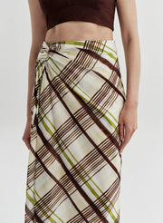 Plaid skirt with brown and green pattern on a plain background