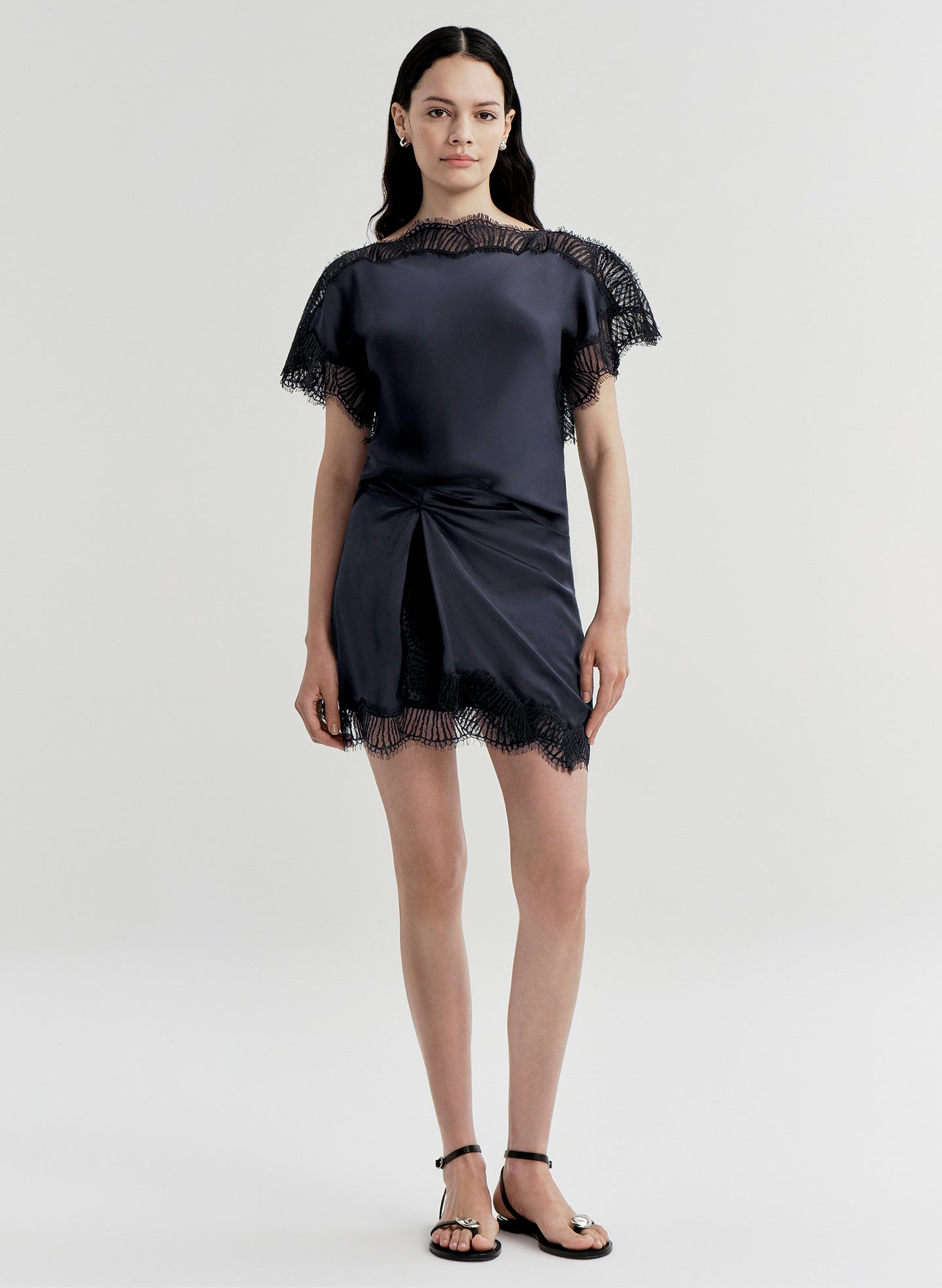 woman wearing blue satin and lace top with matching mini skirt