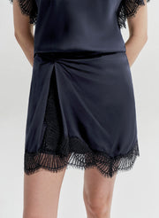 Navy blue miniskirt with lace trim on a white background