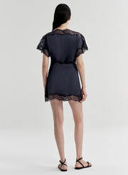 woman wearing blue satin and lace top with matching mini skirt