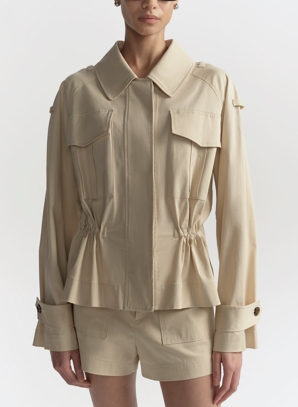 Beige jacket and shorts set on a white background