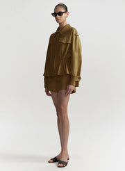 Person wearing a hazel brown outfit on a white background