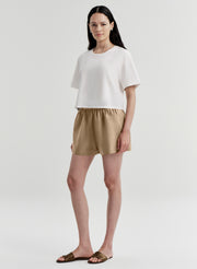 woman wearing white tshirt and tan shorts