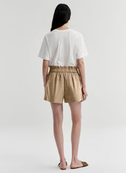woman wearing white tshirt and tan shorts