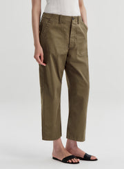 Person wearing olive green pants on a white background