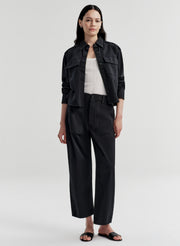 Woman wearing a navy blue outfit on a white background