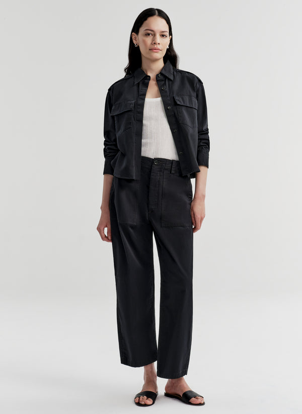 Woman wearing a navy blue outfit on a white background