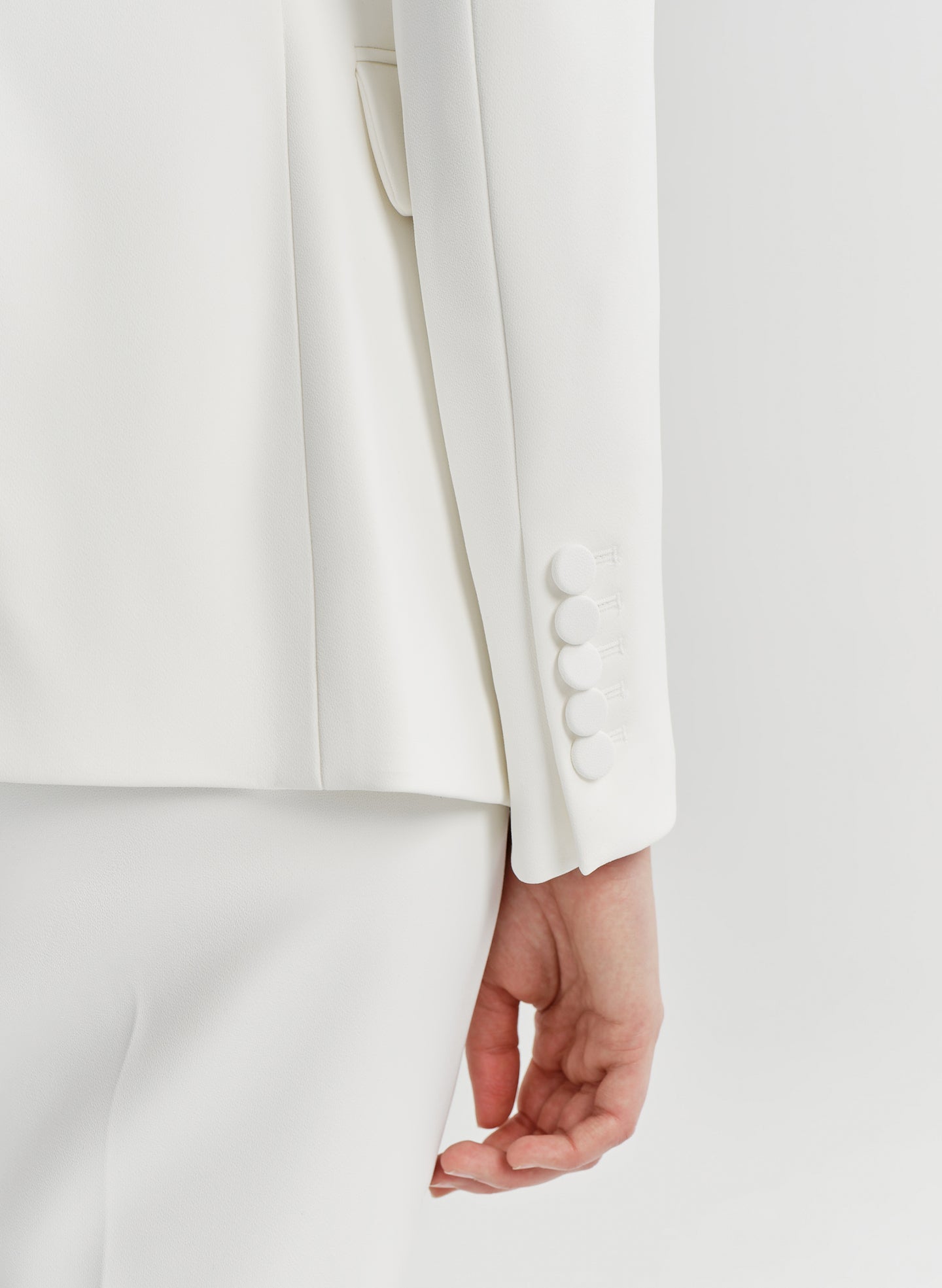 close up of woman wearing white suit