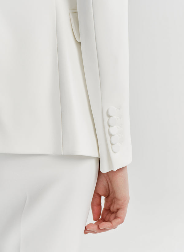 close up of woman wearing white suit