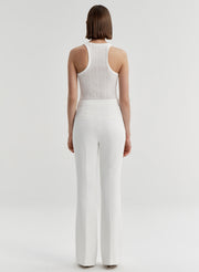 woman wearing white tank top and white pants