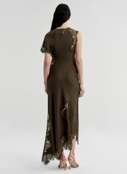 Woman wearing a brown dress with lace details on a white background