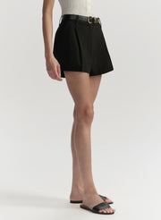 Person wearing a black short with a belt on a white background