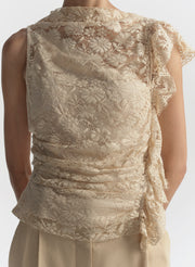 woman wearing cream lace top and tan pants