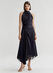 Woman wearing a blue pleated dress on a white background