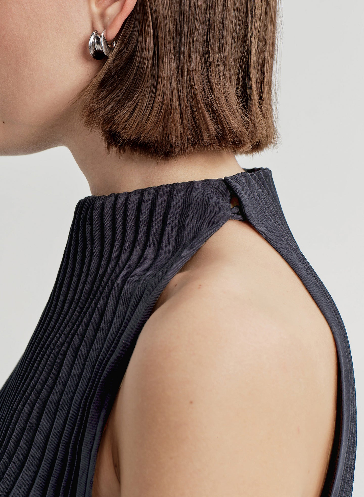 Person wearing a blue dress with a plain background