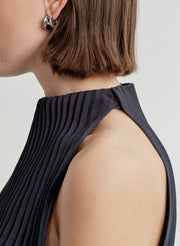 Person wearing a blue dress with a plain background