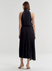 Woman wearing a blue pleated dress on a white background