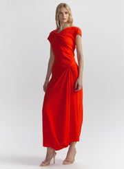 Woman wearing a red-orange dress on a white background